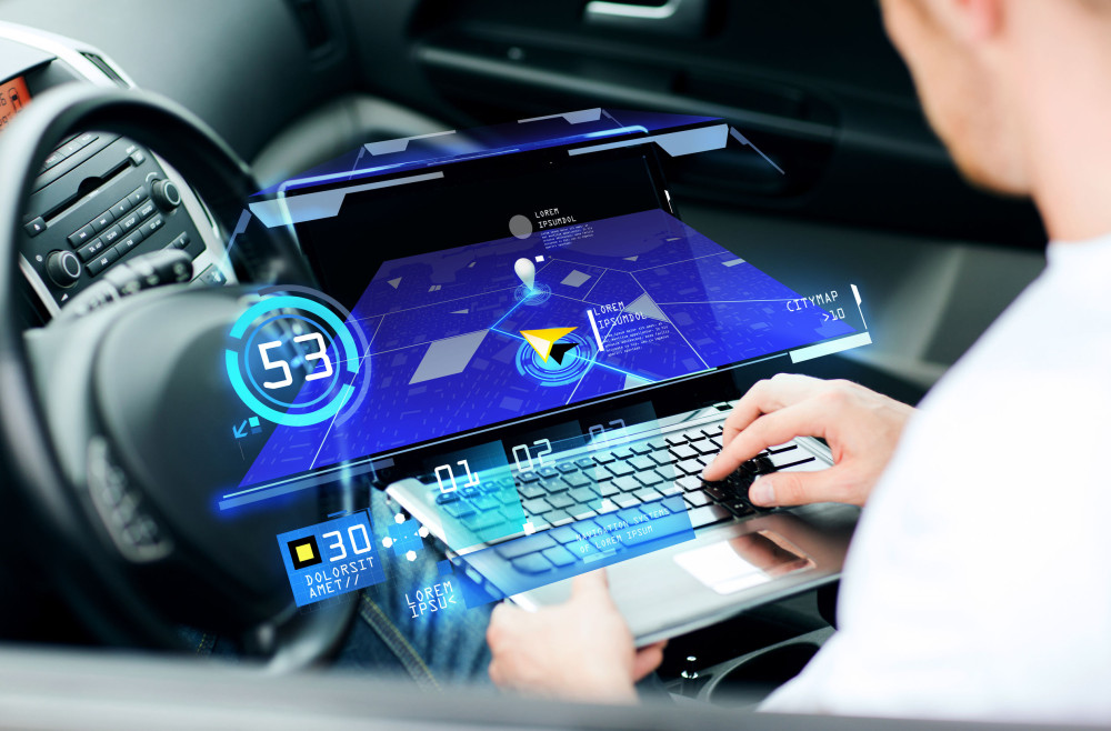 man using navigation on laptop computer in car